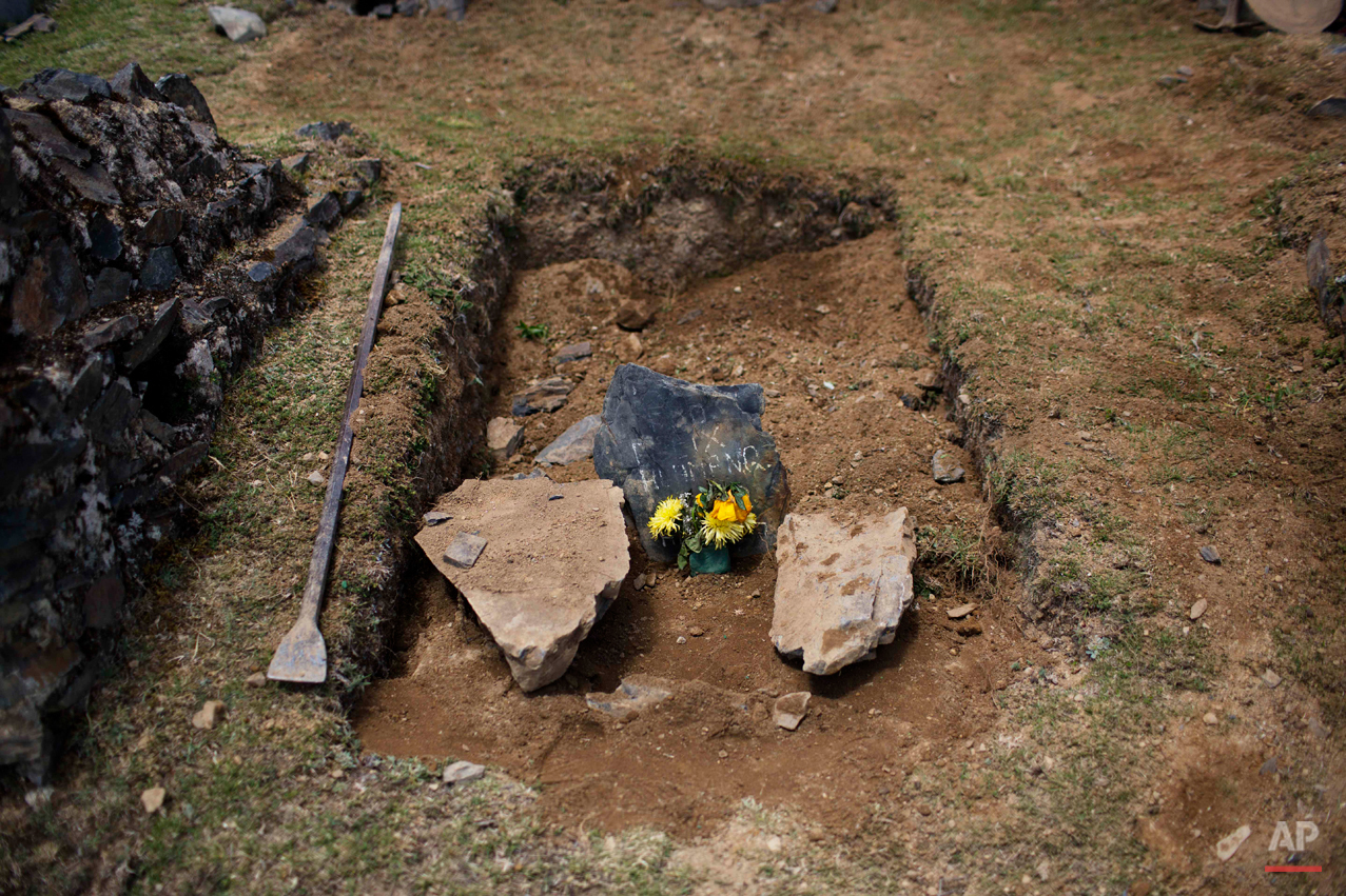  This Oct. 29, 2014 photo shows the tomb of Felix Huaman after his burial at the cemetery in Huallhua in Peru's Ayahuanco region. Huaman's remains were exhumed and handed over to relatives only recently, allowing them to bury him properly years after