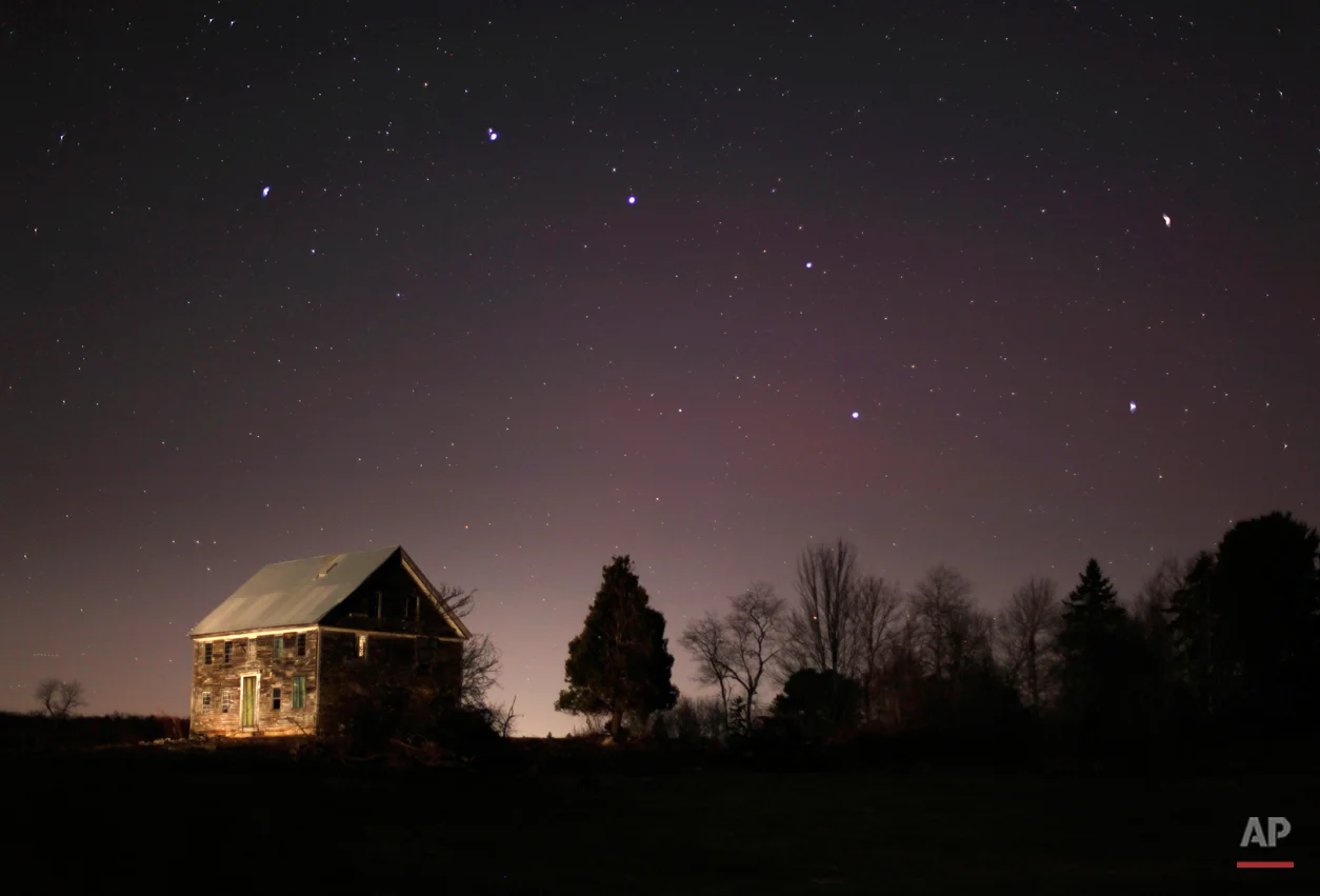 In this Nov. 11, 2010 photo, the big dipper shines in the evening sky over a 212-year-old farm house in Brunswick, Maine. (AP Photo/Robert F. Bukaty)