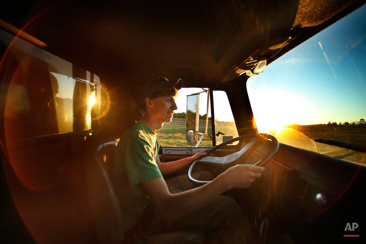 In this photo made Wednesday, Sept. 24, 2014, Nick Powers, 16, drives a 60,000-pound load of potatoes from a field to a storage facility in Mapleton, Maine. Powers is a junior at Presque Isle High School, one of a half-dozen schools that close for up to three weeks each autumn as kids help to bring in the potato crop. Educators and farmers are clinging to a tradition that give farmers much-needed help and puts money in the pockets of teenagers. (AP Photo/Robert F. Bukaty)