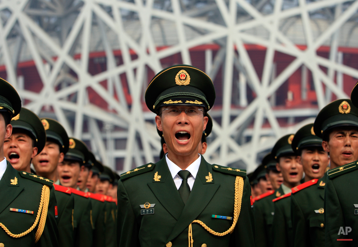  Chinese paramilitary police officers take an oath to ensure safety during the 2008 Beijing Olympics, in a drill outside the Bird's Nest National Stadium, Wednesday, July 23, 2008, in Beijing.  (AP Photo/Robert F. Bukaty) 