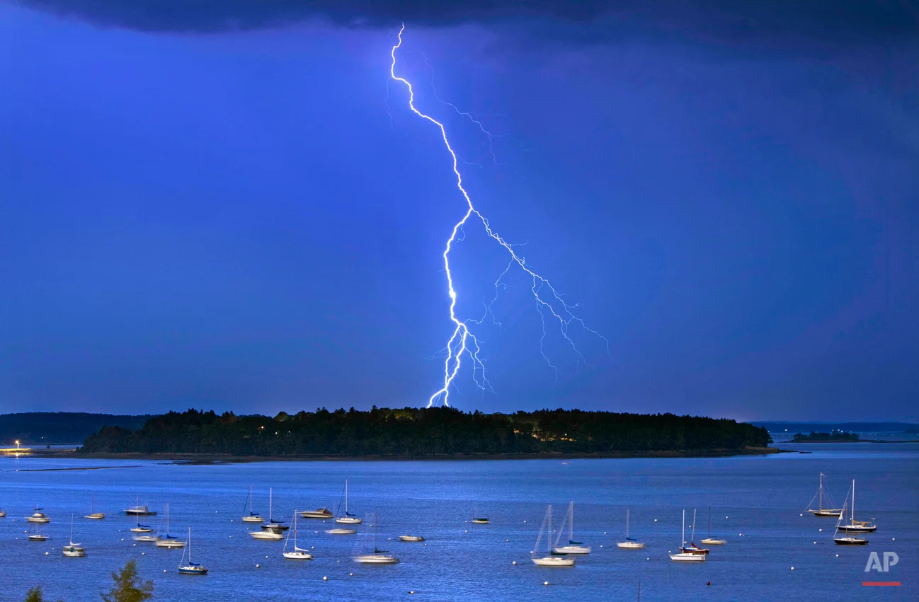In this photo made Wednesday, Sept. 11, 2013, lightning strikes north of Macworth Island in Portland, Maine. There were more than 1,000 lightning strikes per hour at the height of the storm, according to the National Weather Service. Trees and power lines were knocked down across the region, and an electric substation was damaged. (AP Photo/Robert F. Bukaty)