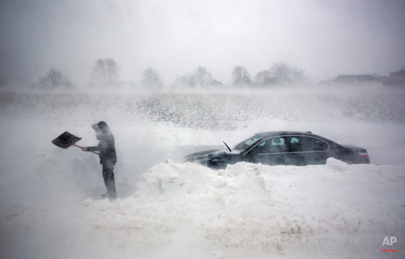  A woman digs out her car after it was blocked in by drifting snow during a blizzard, Saturday, Feb. 9, 2013, in Portland, Maine. The storm dumped more than 30 inches of snow as of Saturday afternoon, breaking the record for the biggest storm on reco