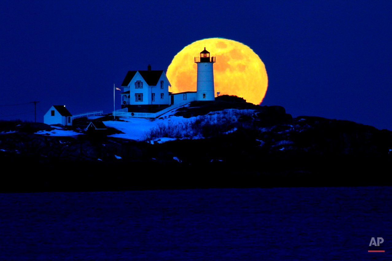  The full moon rises behind Cape Neddick Light, also known as Nubble Light, Feb. 9, 2009, in York, Maine. The February full moon is known as the snow moon. (AP Photo/Robert F. Bukaty) 