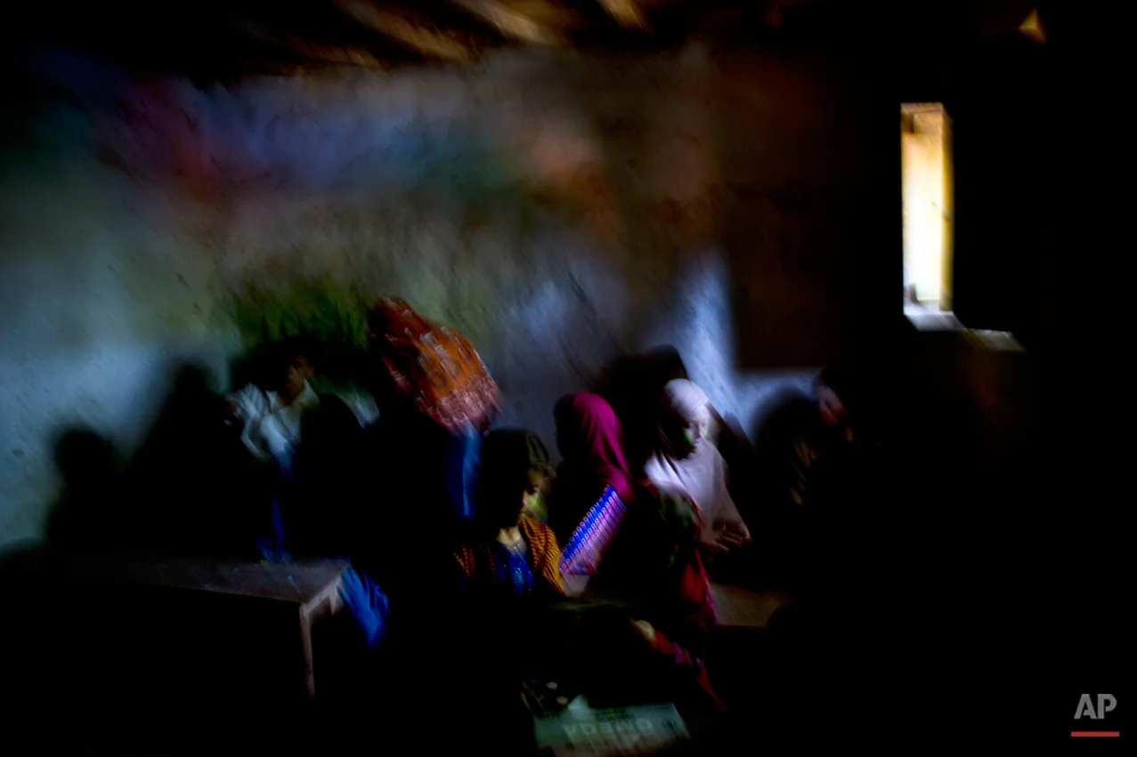 In this Tuesday, Aug. 19, 2014, photo, Afghan refugees and internally displaced Pakistani school children attend their first day of school in a makeshift classroom on the outskirts of Islamabad, Pakistan. Malala Yousafzai's struggle for girls to be educated in a deeply conservative society led to her shooting by the Taliban two years ago, while her relentless campaign for women's rights was rewarded Friday, Oct. 10, 2014, by the recognition of her work as she was jointly awarded the Nobel Peace Prize. (AP Photo/Muhammed Muheisen)