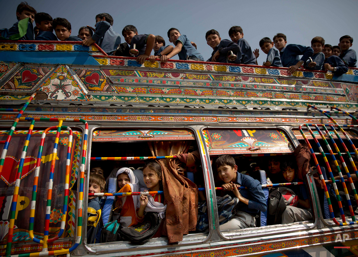  In this Friday, Oct. 4, 2013 photo, Pakistani children crowd on a bus after being picked up from school in Wajah Khiel, Swat Valley, Pakistan. Malala Yousafzai's struggle for girls to be educated in a deeply conservative society led to her shooting 