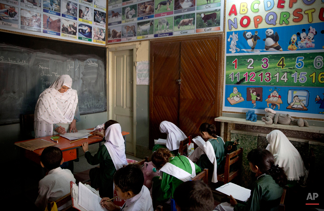  In this Saturday, Oct. 5, 2013 photo, Pakistani children attend class in a school in Mingora, Swat Valley, Pakistan. Taliban attack survivor Malala Yousafzai of Pakistan won the Nobel Peace Prize on Friday, Oct. 10, 2014, for risking their lives to 