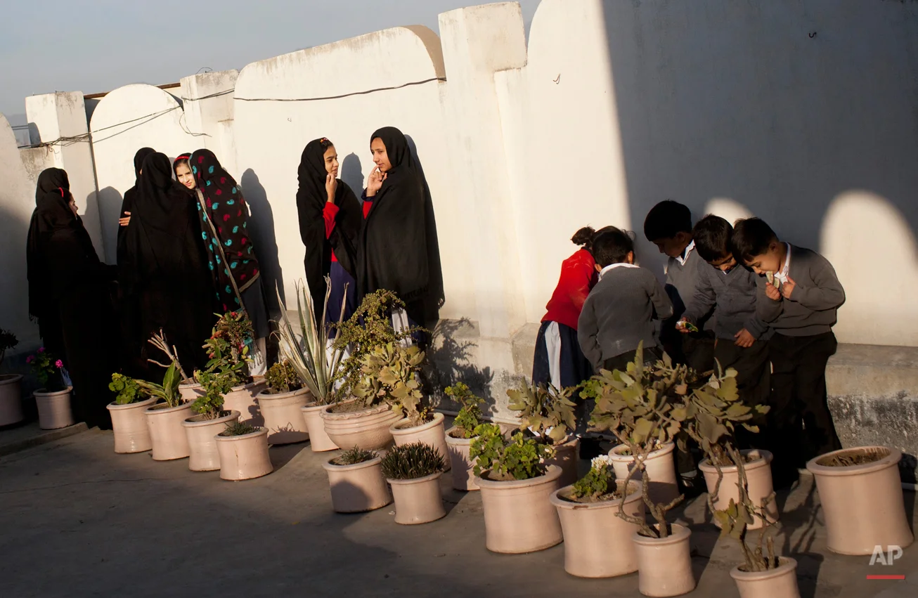 In this Thursday, Nov. 15, 2012 photo, Pakistani school children gather at the patio of the Khushal School for Girls in Mingora, Swat Valley, Pakistan. Malala Yousafzai's struggle for girls to be educated in a deeply conservative society led to her shooting by the Taliban two years ago, while her relentless campaign for women's rights was rewarded Friday, Oct. 10, 2014, by the recognition of her work as she was jointly awarded the Nobel Peace Prize. ( AP Photo/Anja Niedringhaus)