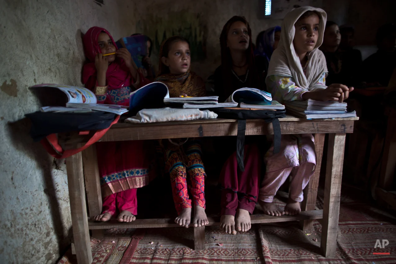 In this Tuesday, Sept. 23, 2014, photo, Afghan refugees and internally displaced Pakistani school children attend their classes at a makeshift school on the outskirts of Islamabad, Pakistan. Taliban attack survivor Malala Yousafzai of Pakistan won the Nobel Peace Prize on Friday, Oct. 10, for risking their lives to fight for children's rights. Malala, who moved to Britain for treatment and later settled there, tirelessly continued her campaign for a woman's right to an education in Pakistan and won international recognition for her struggle. But in Pakistan that effort has not stopped as young girls and women struggle to get an education. (AP Photo/Muhammed Muheisen)