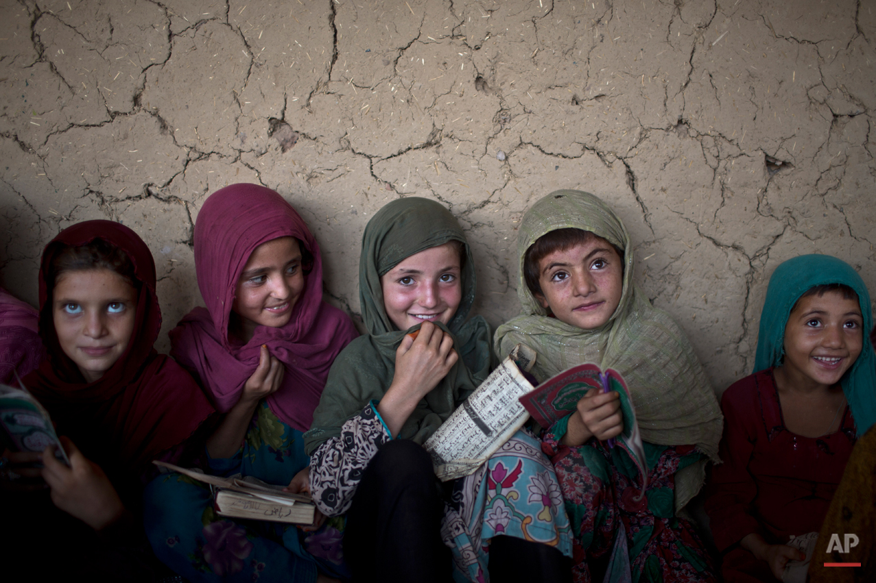  In this Monday, Aug. 11, 2014, photo, Afghan refugee girls listen to their teacher during their daily Madrassa, or Islamic school, at a mosque on the outskirts of Islamabad, Pakistan. Taliban attack survivor Malala Yousafzai of Pakistan won the Nobe