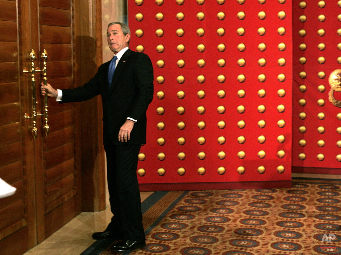  U.S. President George W. Bush reacts as he pulls on a locked door as he tries to leave a press conference in Beijing, China, Sunday, Nov. 20, 2005. Bush headed for a set of double doors after the press conference only to discover that they were lock