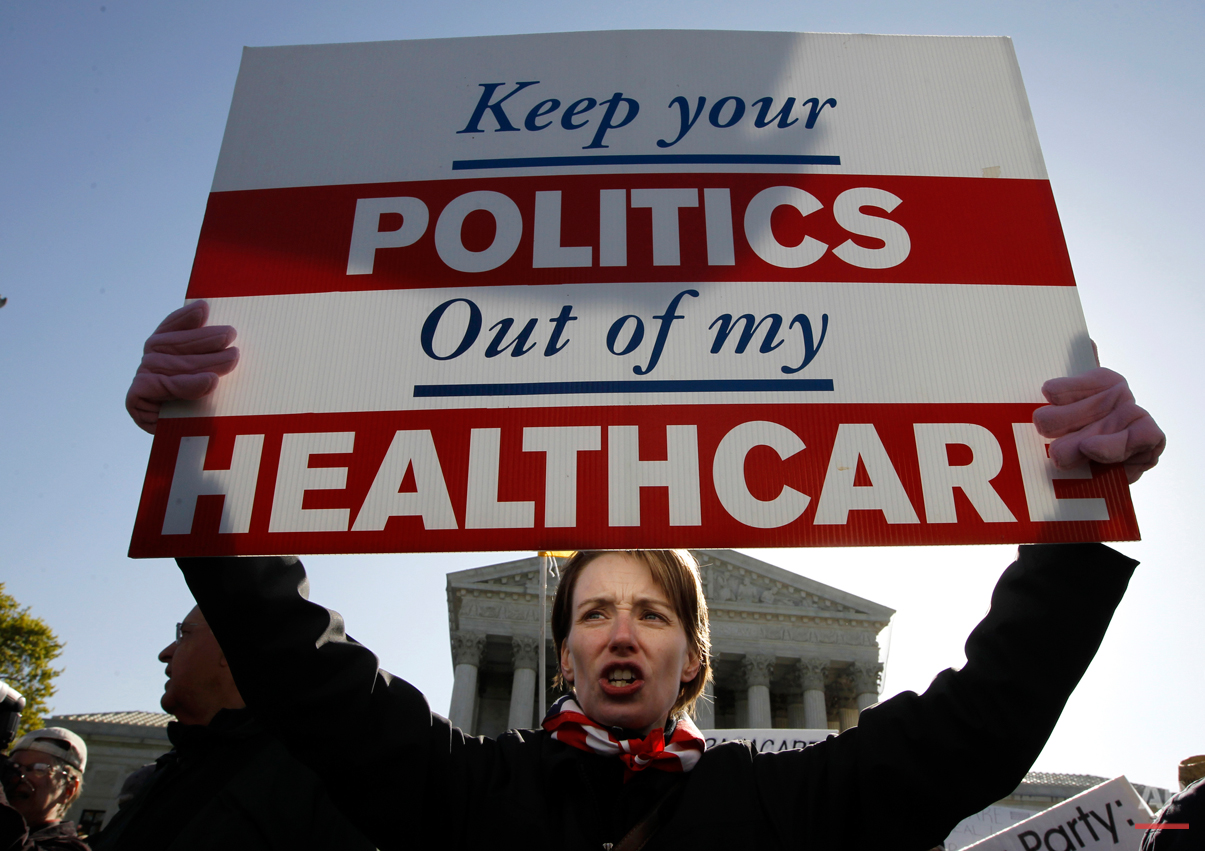  Amy Brighton from Medina, Ohio, who opposes health care reform, rallies in front of the Supreme Court  in Washington, Tuesday, March 27, 2012, as the court continues arguments on the health care law signed by President Barack Obama. (AP Photo/Charle