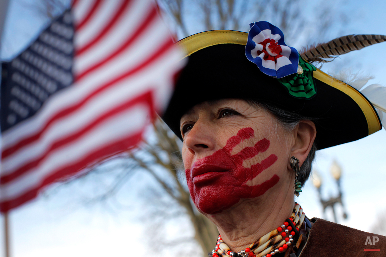  Susan Clark of Santa Monica, Calif., who opposes health care reform, stands with a red hand painted over her mouth to represent what she said is socialism taking away her choices and rights, in front of the Supreme Court in Washington, Wednesday, Ma