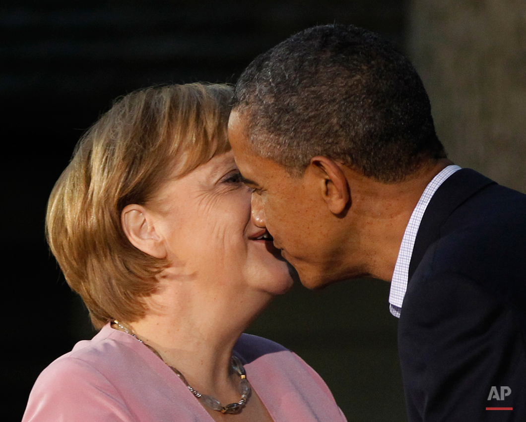  President Barack Obama gives German Chancellor Angela Merkel a kiss on the cheek on arrival for the G8 Summit Friday, May 18, 2012 at Camp David, Md. (AP Photo/Charles Dharapak) 