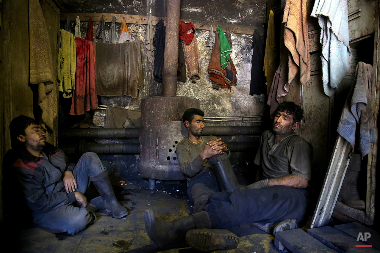  In this Tuesday, May 6, 2014 photo, Iranian coal miners rest during a break at a mine on a mountain in Mazandaran province, near the city of Zirab, 212 kilometers (132 miles) northeast of the capital Tehran, Iran. The miners put in long hours in oft