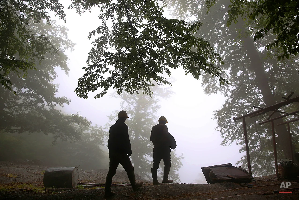 In this Thursday, May 8, 2014 photo, Iranian coal miners make their way home after a long day of work at a mine on a mountain in Mazandaran province, near the city of Zirab, 212 kilometers (132 miles) northeast of the capital Tehran. Iran's ministry of industry, mines and commerce says it has plans for improving the working conditions of miners alongside a drive to boost the production of minerals. Deputy Minister Jafar Sargheini says the ministry will grant loans and aid as part of the four-year plan for the sector, which will include safety improvements. (AP Photo/Ebrahim Noroozi)