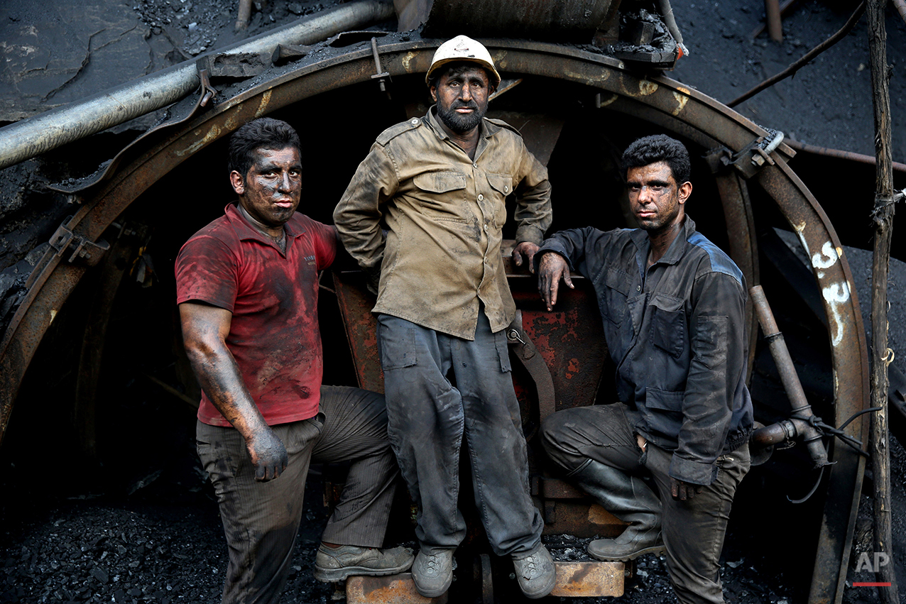  In this Monday, Aug. 18, 2014 photo, Iranian coal miners pose for a photograph at a mine on a mountain in Mazandaran province, near the city of Zirab 212 kilometers (132 miles) northeast of the capital Tehran, Iran. International sanctions linked to