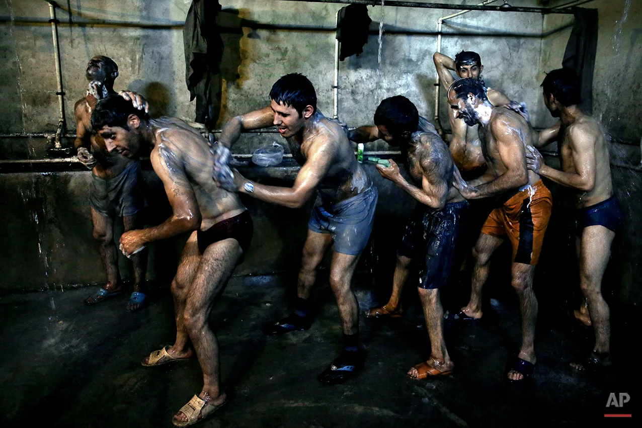 In this Tuesday, May 6, 2014 photo, Iranian coal miners shower after a long day of work at a mine on a mountain in Mazandaran province, near the city of Zirab, 212 kilometers (132 miles) northeast of the capital Tehran, Iran. Workers who put in 12 hours a day - often in dangerous conditions - make just $300 a month. (AP Photo/Ebrahim Noroozi)