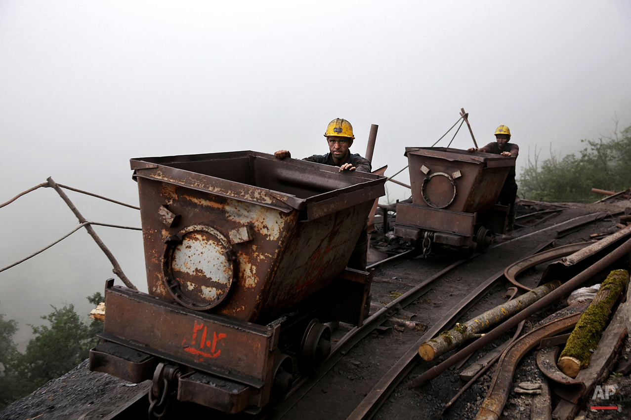  In this Thursday, May 8, 2014 photo, Iranian coal miners push metal carts to be loaded with coal at a mine near the city of Zirab 212 kilometers (132 miles) northeast of the capital Tehran, on a mountain in Mazandaran province, Iran. International s