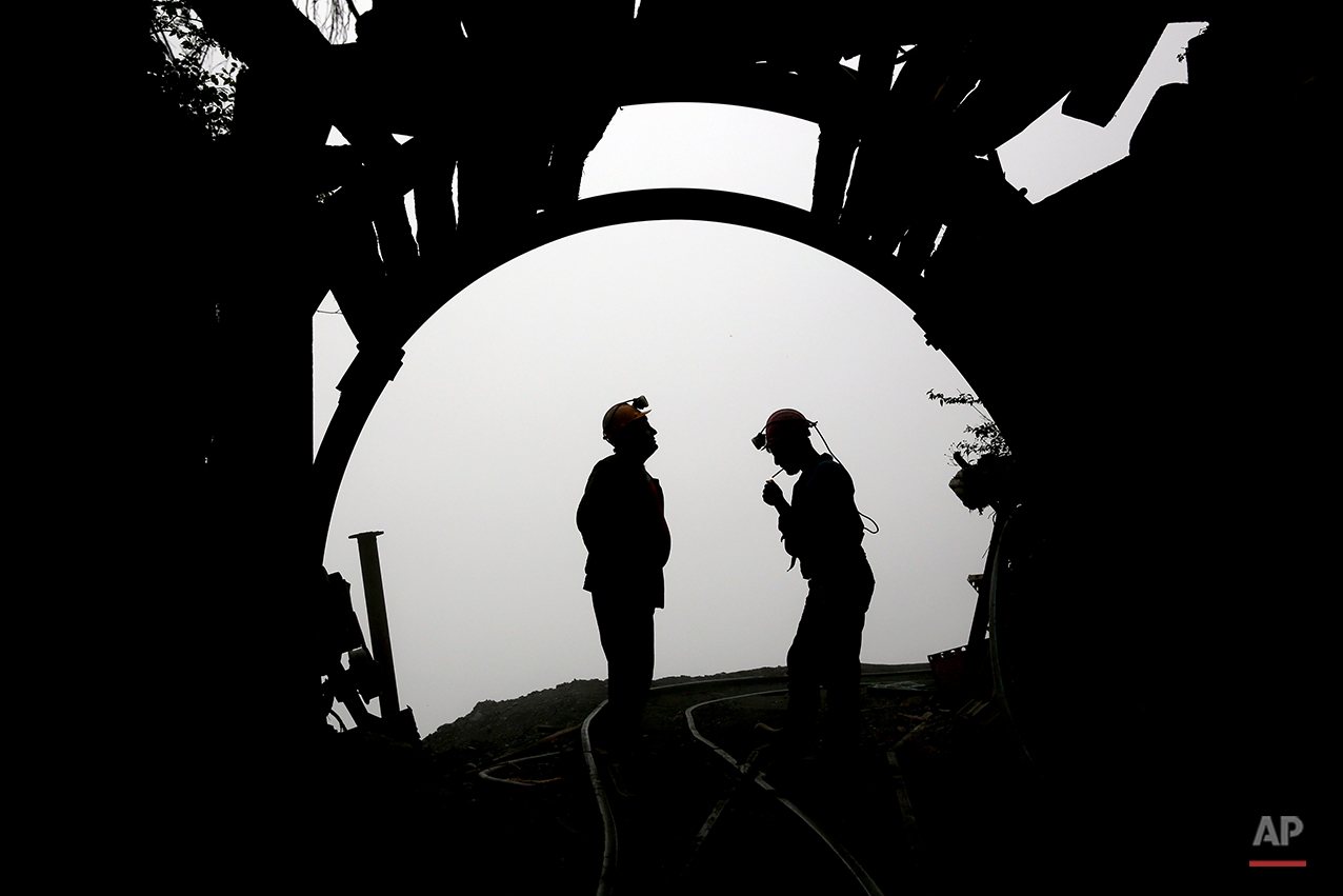  In this Thursday, May 8, 2014 photo, a coal miner lights a cigarette after a long of work at a mine near the city of Zirab 212 kilometers (132 miles) northeast of the capital Tehran, on a mountain in Mazandaran province northern Iran. Around 1,200 m