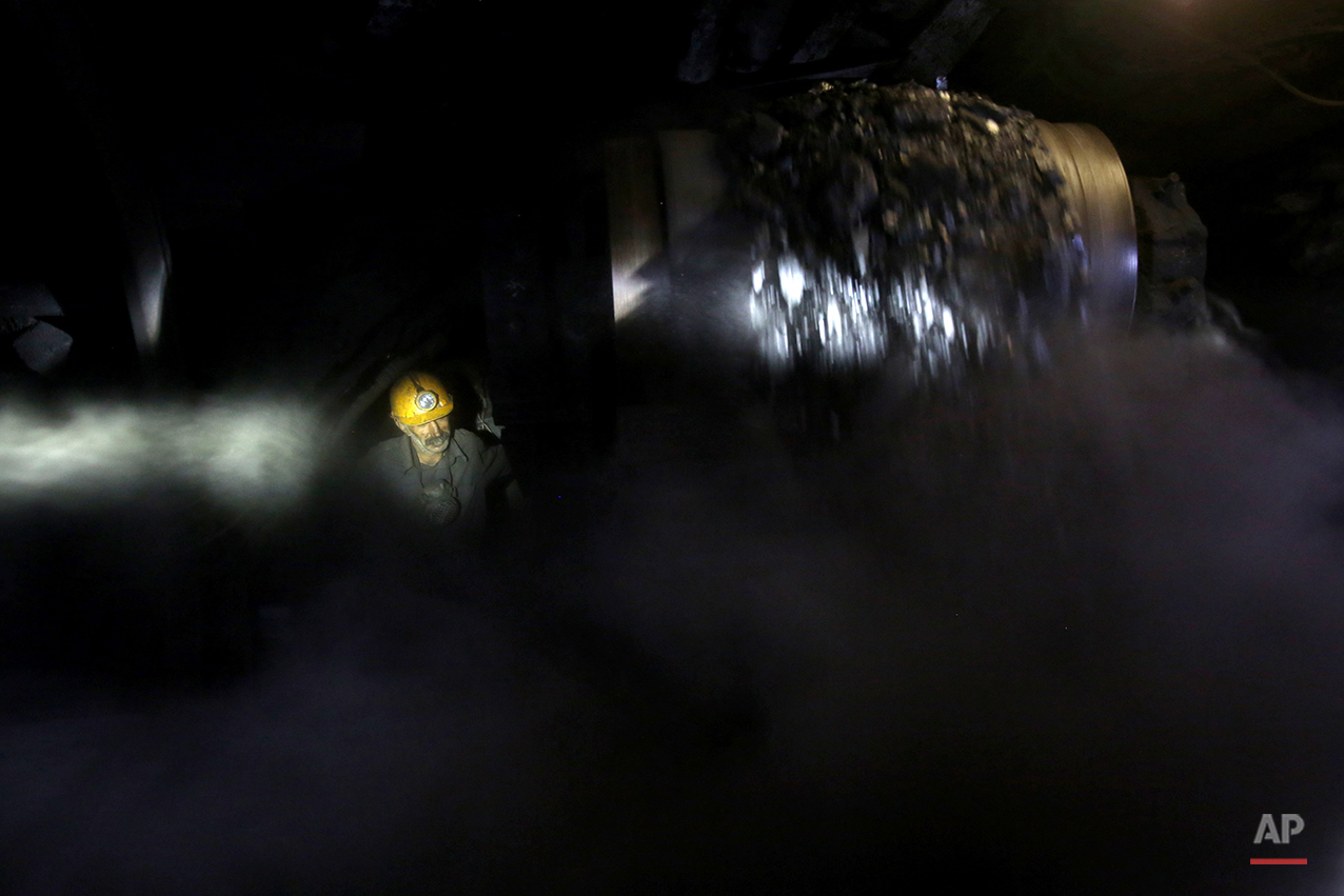  In this Tuesday, Aug. 19, 2014 photo, an Iranian coal miner works inside a mine near the city of Zirab 212 kilometers (132 miles) northeast of the capital Tehran, on a mountain in Mazandaran province, Iran. The miners tunnel deep into the mountains,