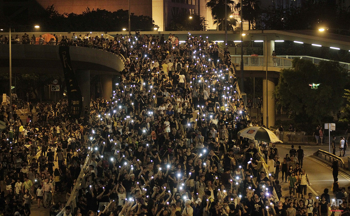  Tens of thousands of pro-democracy demonstrators, some waving lights from mobile phones,  fill the streets in the main finical district of Hong Kong, Wednesday, Oct. 1, 2014. Student leaders of pro-democracy protests in Hong Kong warned Wednesday th