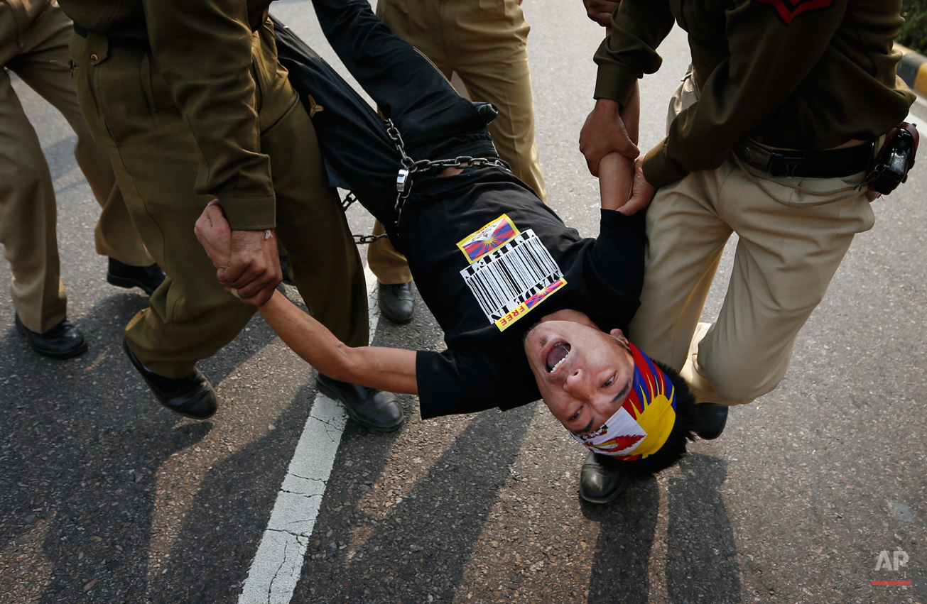  Indian policemen detain a Tibetan Youth Congress (TYC) supporter as he protests outside the Chinese Embassy in New Delhi, India, Monday, Nov. 12, 2012. TYC supporters shouted anti-Chinese government slogans outside the embassy to show support to Tib