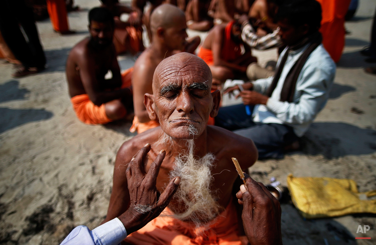  Hindu holy men get their beards and heads shaved before being initiated as Naga sadhus or naked Hindu holy men at the Maha Kumbh festival in Allahabad, India, Wednesday, Feb. 13, 2013. The significance of nakedness is that one will not have any worl
