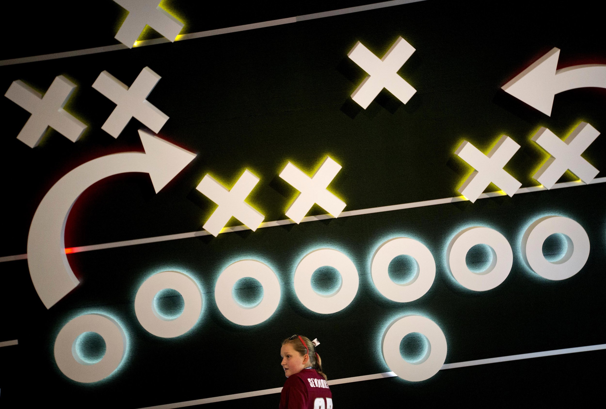  Klava Johnson, 12, of Dunwoody, Ga., stands in front of an interactive exhibit while touring the College Football Hall of Fame, Wednesday, Aug. 13, 2014, in Atlanta. Exhibits incuding a coaching video tutorial help explain how a play is constructed 