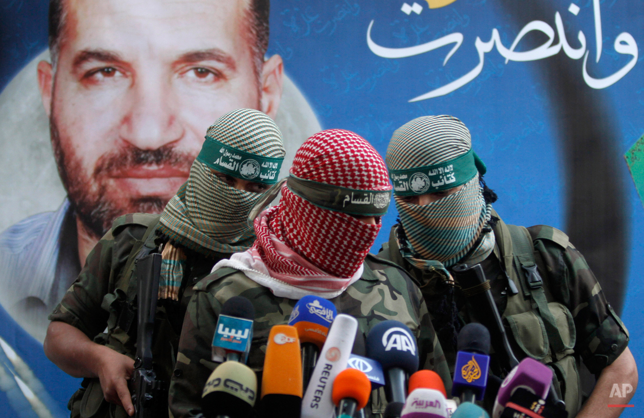  A Hamas militant talks during a press conference in Gaza City, Thursday, Nov. 22, 2012. Gazans are celebrating a cease-fire agreement reached with Israel to end eight days of the fiercest fighting in nearly four years constricting the Gaza Strip. Th