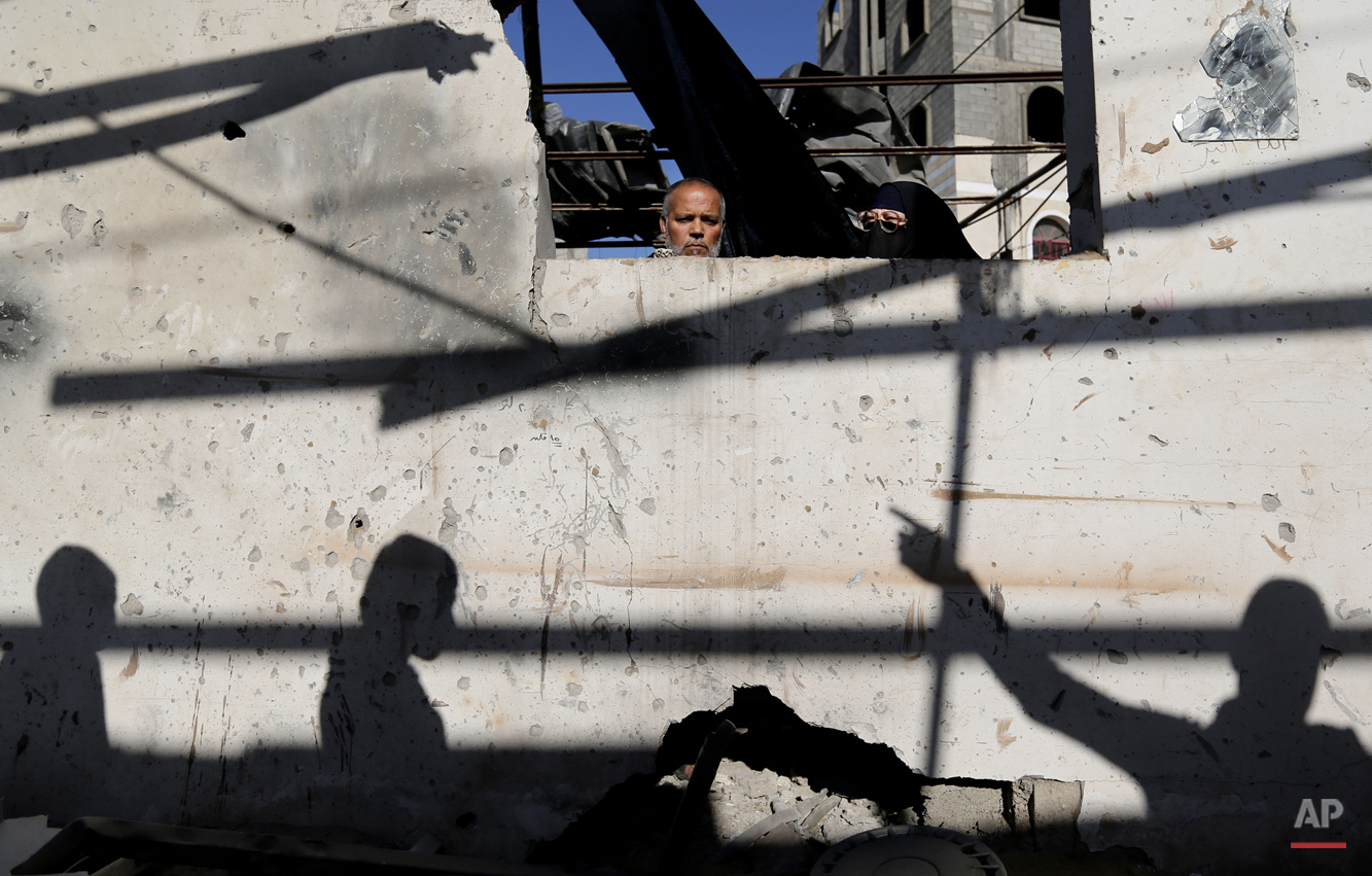  Palestinians inspect damages of their home after an Israeli airstrike in Gaza City, Thursday, Jan. 16, 2014. Israel's military says it has carried out air strikes in the Gaza Strip after militants there launched five rockets toward Israel. A Gaza he