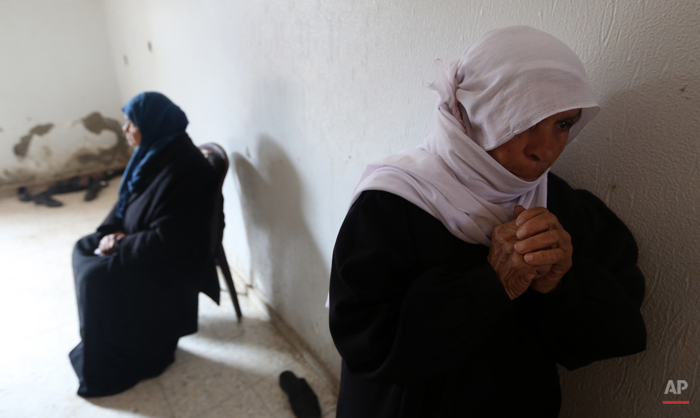  Palestinian women mourn during the funeral of Ibrahim Suliman Mansour during his funeral in the Shajaiyeh neighborhood of Gaza City, Friday, Feb. 14, 2014. Health Ministry spokesman Ashraf al-Kidra said the 30-year-old man was shot in the head Thurs