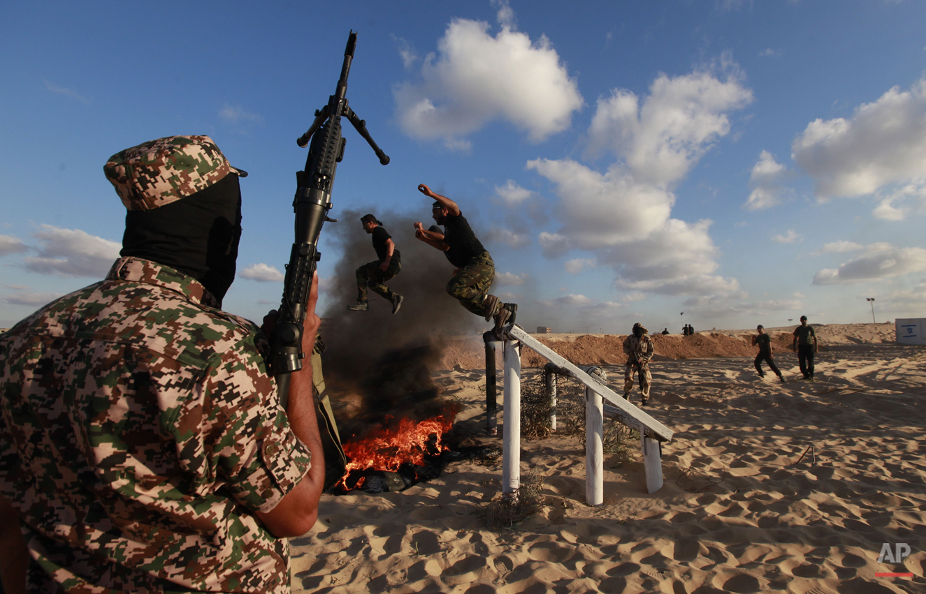  Palestinian militants from Al Nasser Brigades, an armed wing of the Popular Resistance Committees (PRC), participate in a training session in Khan Younis, southern Gaza Strip, Friday, Sept. 27, 2013. (AP Photo/Hatem Moussa) 