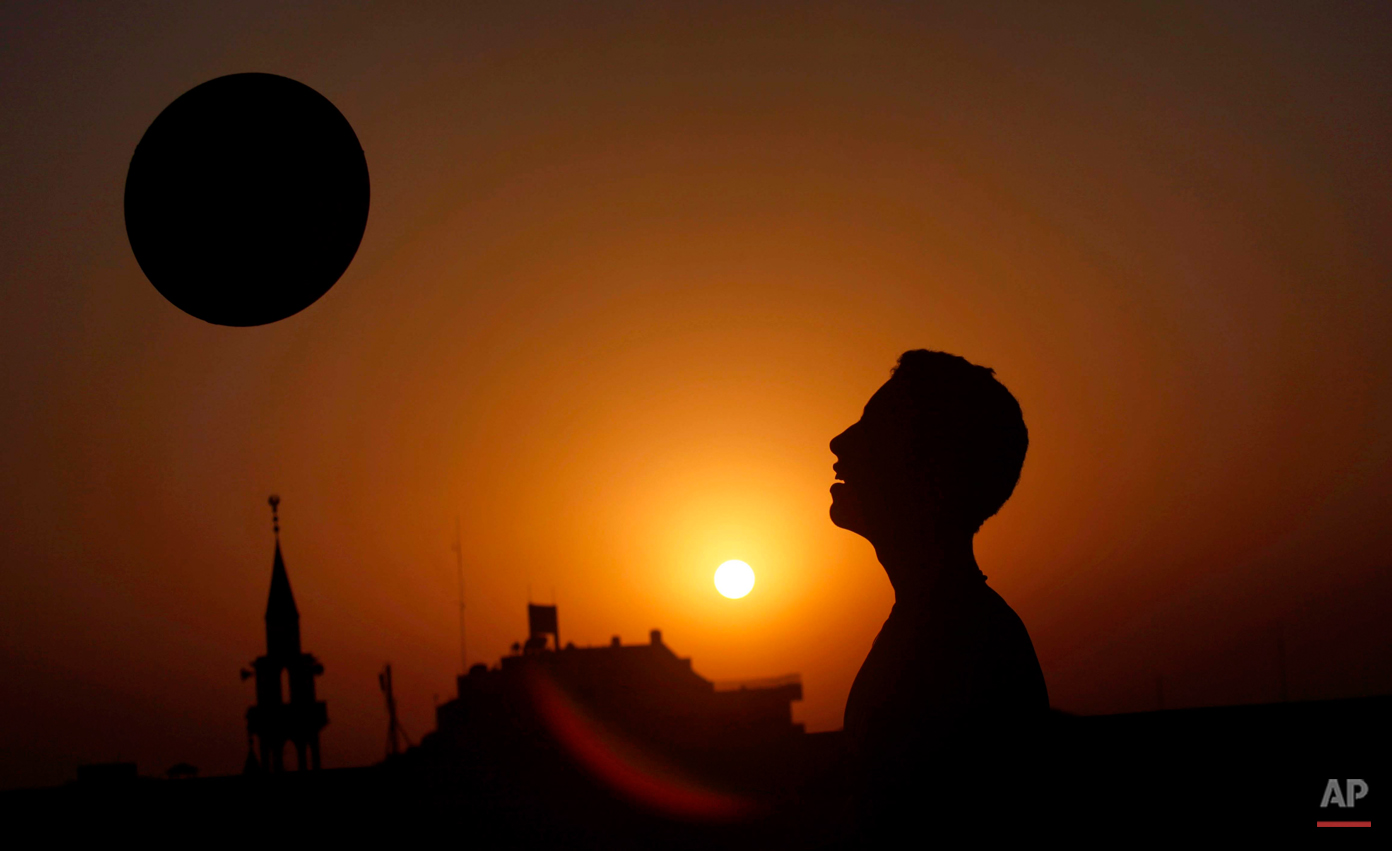  A Palestinian youth plays with a ball, as they sun sets in Gaza City, Tuesday, Oct. 29, 2013. (AP Photo/Hatem Moussa) 