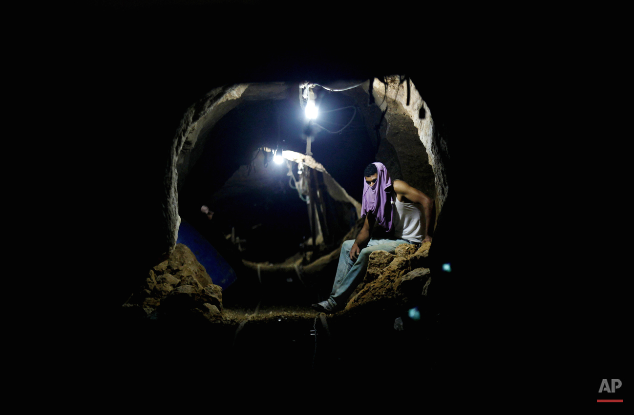  In this Monday, Sept. 30, 2013 photo, a Palestinian worker rests inside a smuggling tunnel in Rafah, on the border between Egypt and the southern Gaza Strip. Since the summer, Egyptís military has tried to destroy or seal off most of the smuggling t