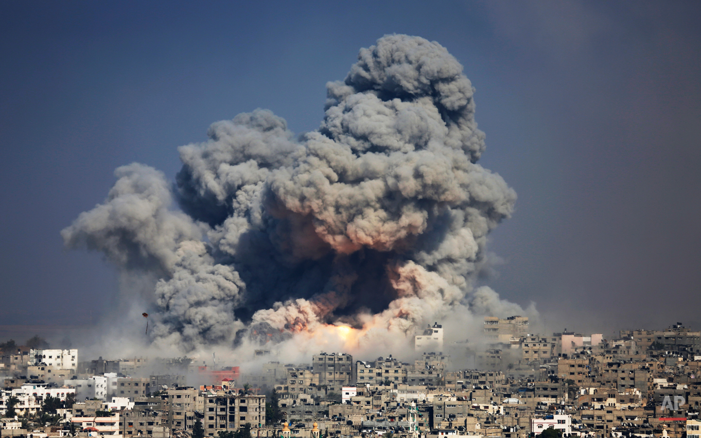  Smoke and fire from the explosion of an Israeli strike rise over Gaza City,  Tuesday, July 29, 2014. Israel escalated its military campaign against Hamas on Tuesday, striking symbols of the group's control in Gaza and firing tank shells that shut do