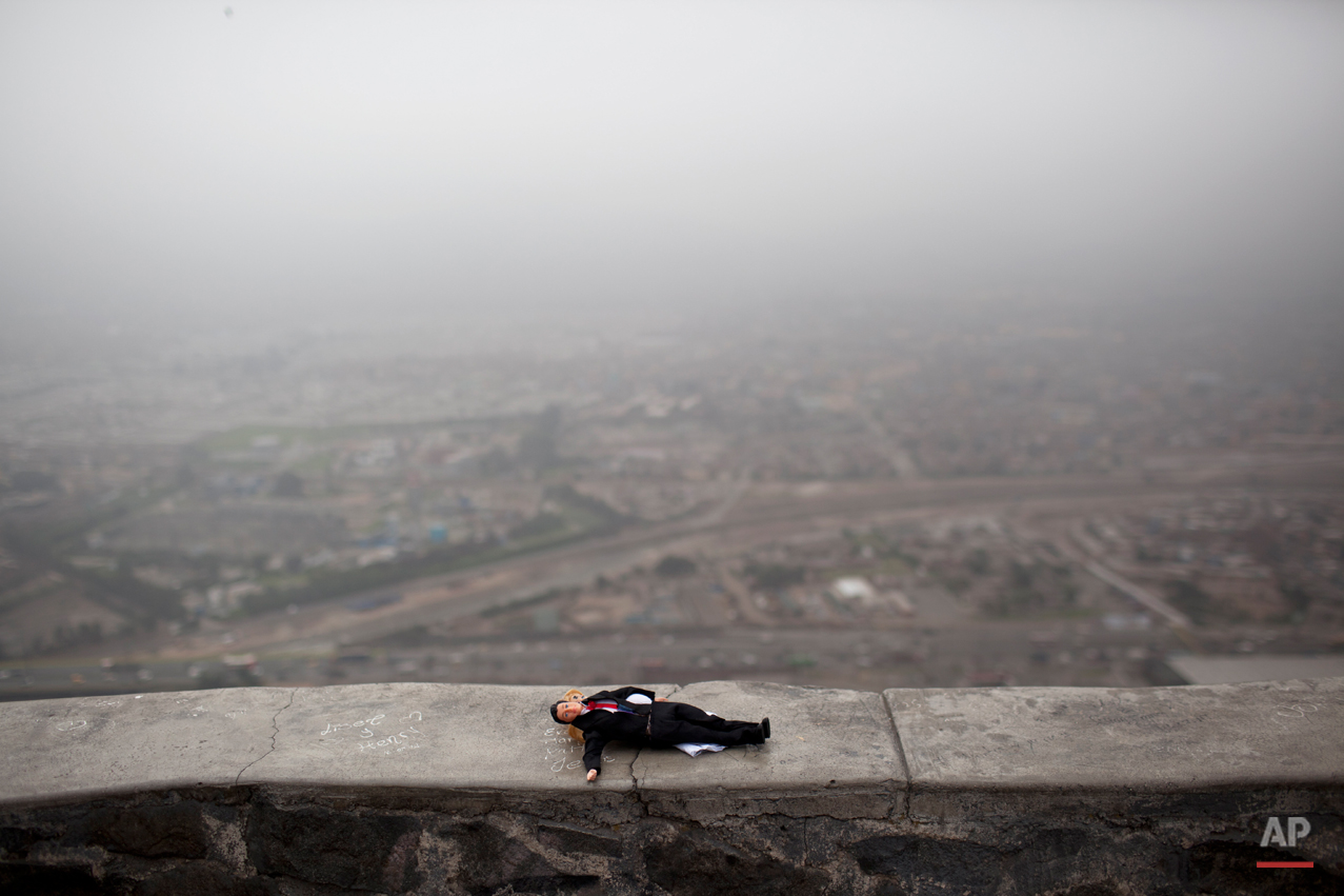  A doll left momentarily by a girl who was playing with it lays on the wall the lookout point from Cerro San Cristobal, Lima, Peru, Monday, Nov. 5, 2012. (AP Photo/Rodrigo Abd) 