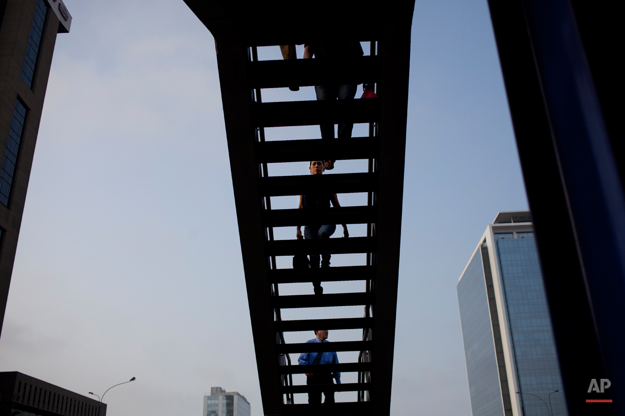 People climb the stairs in a public bus station in Lima, Peru, Thursday, Jan. 24, 2013. (AP Photo/Rodrigo Abd)