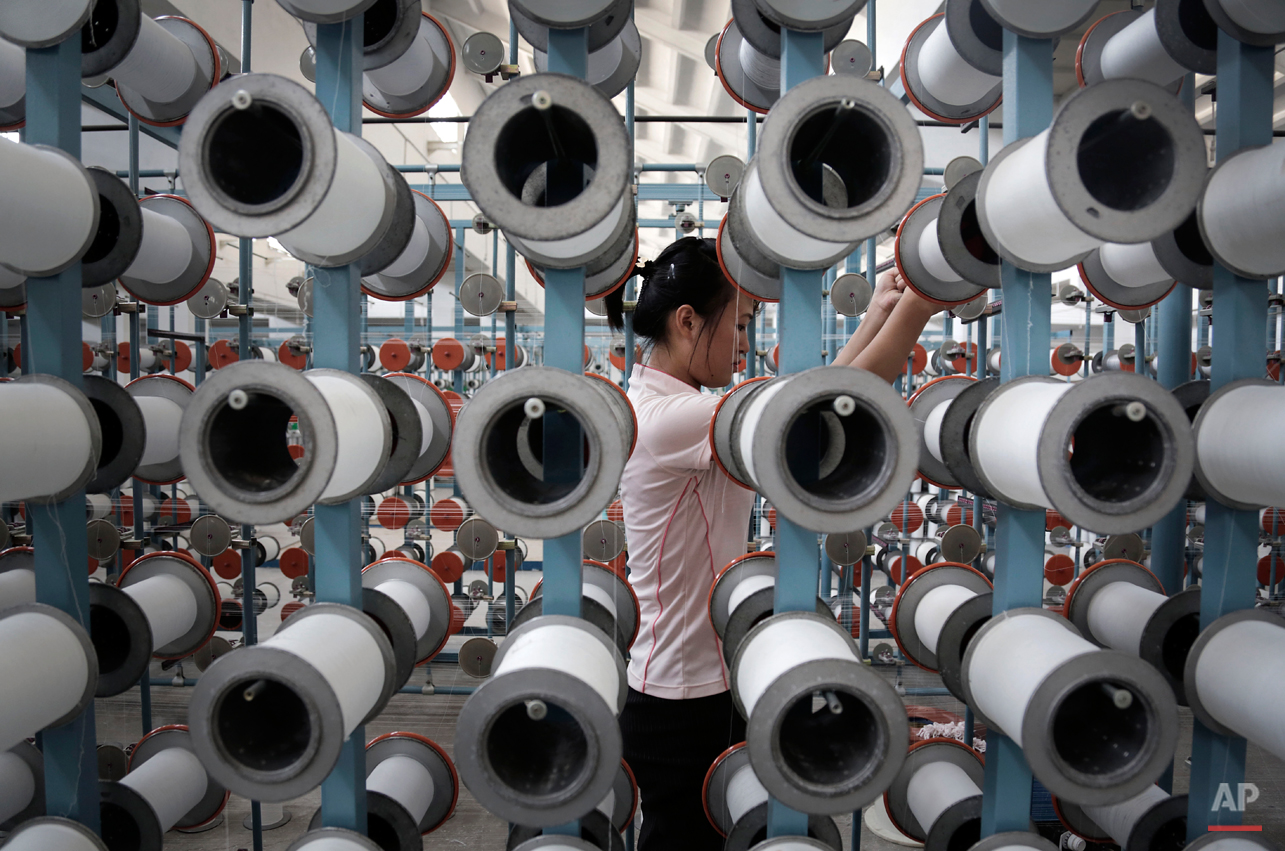  A North Korean woman works at the Kim Jong Suk Pyongyang textile factory, Thursday, July 31, 2014, in Pyongyang, North Korea. This is the country's largest textile factory with 8,500 workers, where eighty percent of them are women.  (AP Photo/Wong M