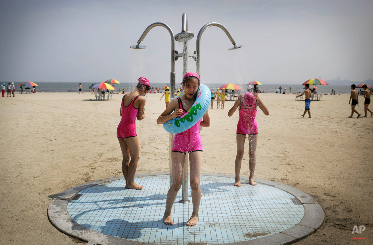 North Korean girls in similar bathing suits stand under a shower at the Songdowon International Children's Camp, Tuesday, July 29, 2014, in Wonsan, North Korea. The camp, which has been operating for nearly 30 years, was originally intended mainly t