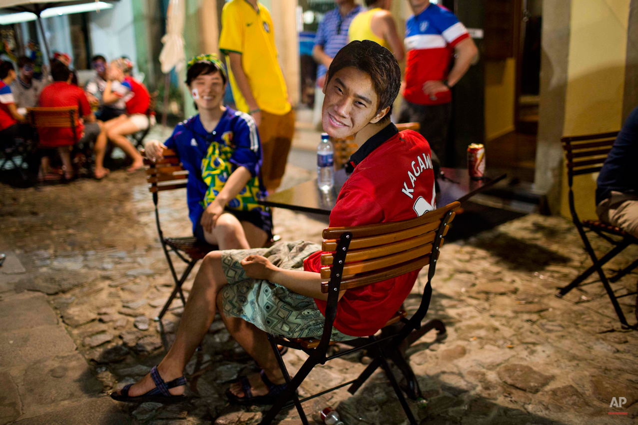  A fan of the Japanese national soccer team sits in a bar wearing a portrait of player Shinji Kagawa in the Pelourinho neighborhood, near the Arena Fonte Nova stadium in Salvador, Brazil, where U.S. and Belgium played a World Cup round of 16 match, T