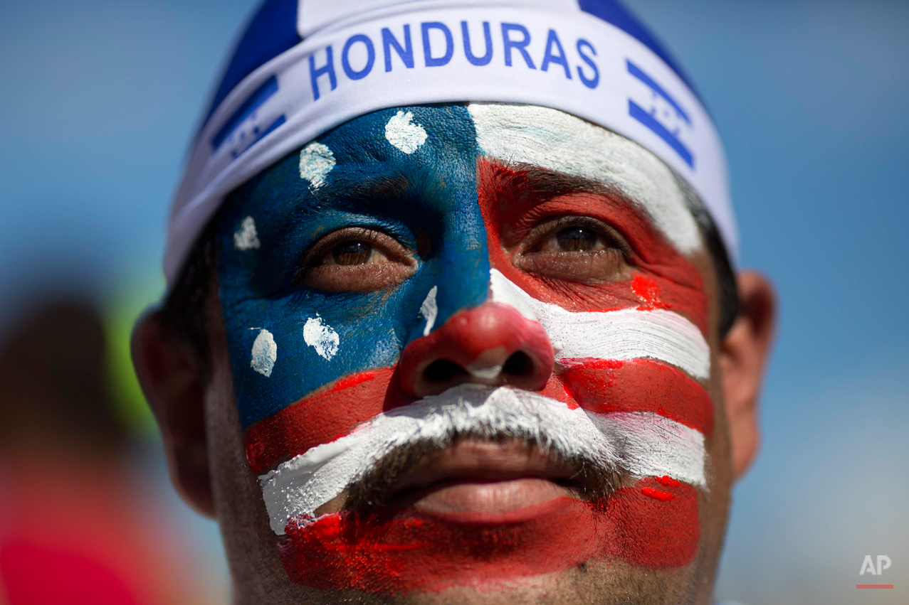  U.S. soccer fan Marco Antonio Sandoval, from Honduras, poses for the picture outside the Arena Fonte Nova stadium before World Cup round of 16 match between the US and Belgium in Salvador, Brazil, Tuesday, July 1, 2014. (AP Photo/Rodrigo Abd) 