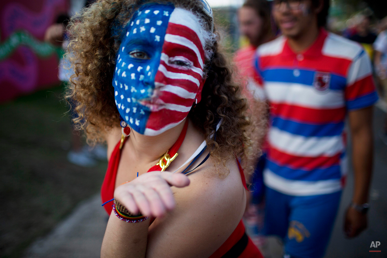  A soccer fan of the U.S. blows a kiss before a World Cup round of 16 match between the U.S. and Belgium, outside the Arena Fonte Nova stadium in Salvador, Brazil, Tuesday, July 1, 2014. (AP Photo/Rodrigo Abd) 