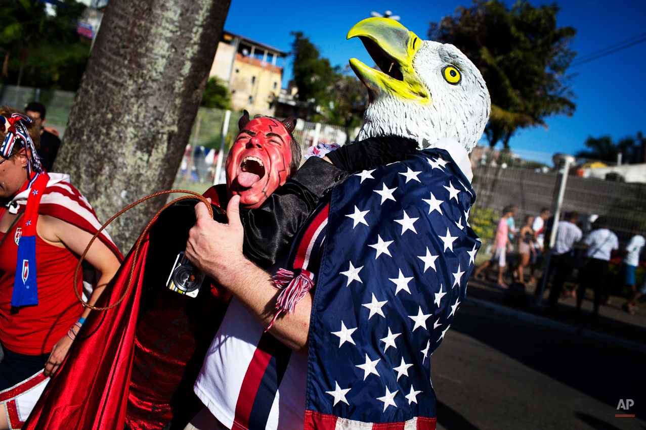  U.S. and Belgium soccer fans cheer together before a World Cup round of 16 match between U.S. and Belgium in Salvador, Brazil, Tuesday, July 1, 2014. (AP Photo/Rodrigo Abd) 