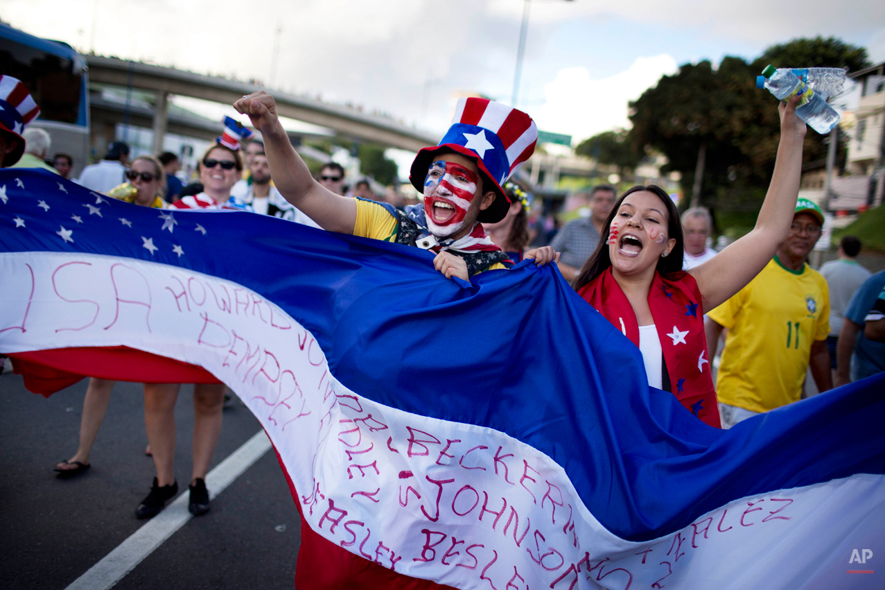  Soccer fans of the United States celebrate before a World Cup round of 16 match between the U.S. and Belgium outside the Arena Fonte Nova stadium in Salvador, Brazil, Tuesday, July 1, 2014. (AP Photo/Rodrigo Abd) 