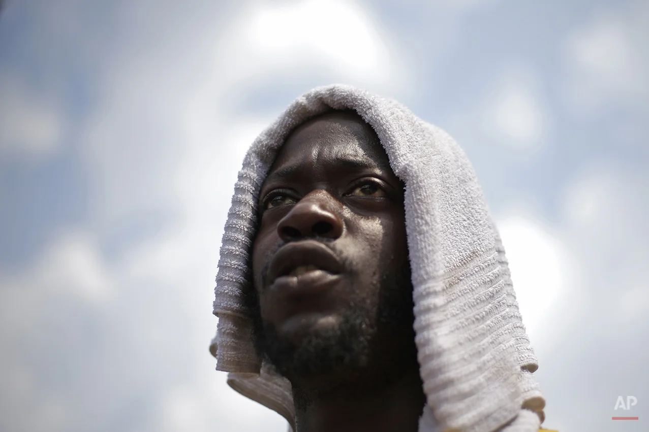 Tour bus salesman Shariff Davis covers his head with a towel on Independence Mall in the heat of the midday Friday, July 19, 2013, in Philadelphia. An excessive heat warning is again in effect for the Philadelphia region with highs expected to head up to the high-90s. (AP Photo/Matt Rourke)