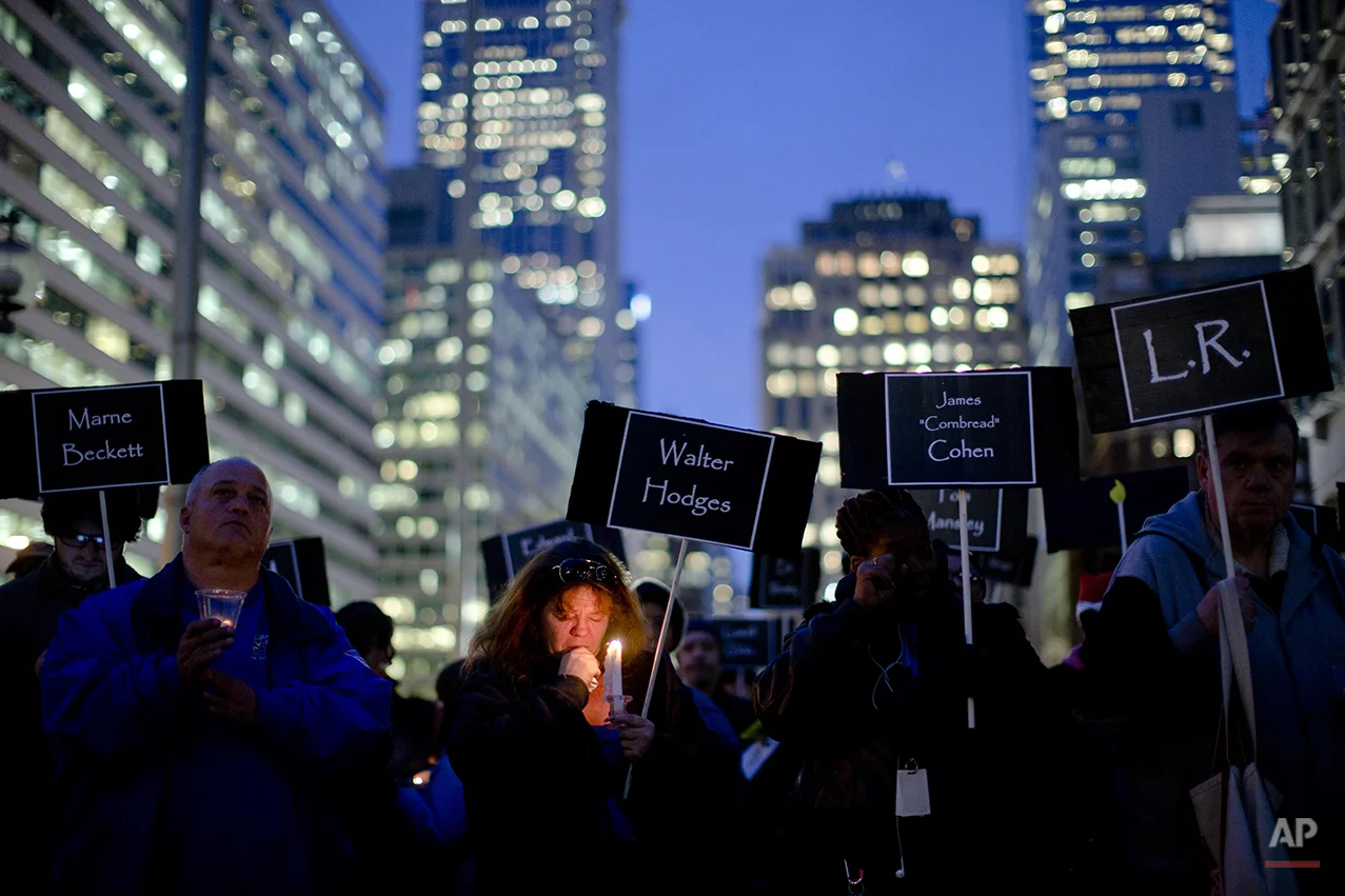 Deborah Young and others gather to remember the homeless and formerly homeless Philadelphians who died in the past year, Thursday, Dec. 19, 2013, in Philadelphia. Nationally, remembrances are scheduled on or near the winter solstice, which is the longest night of the year. (AP Photo/Matt Rourke)