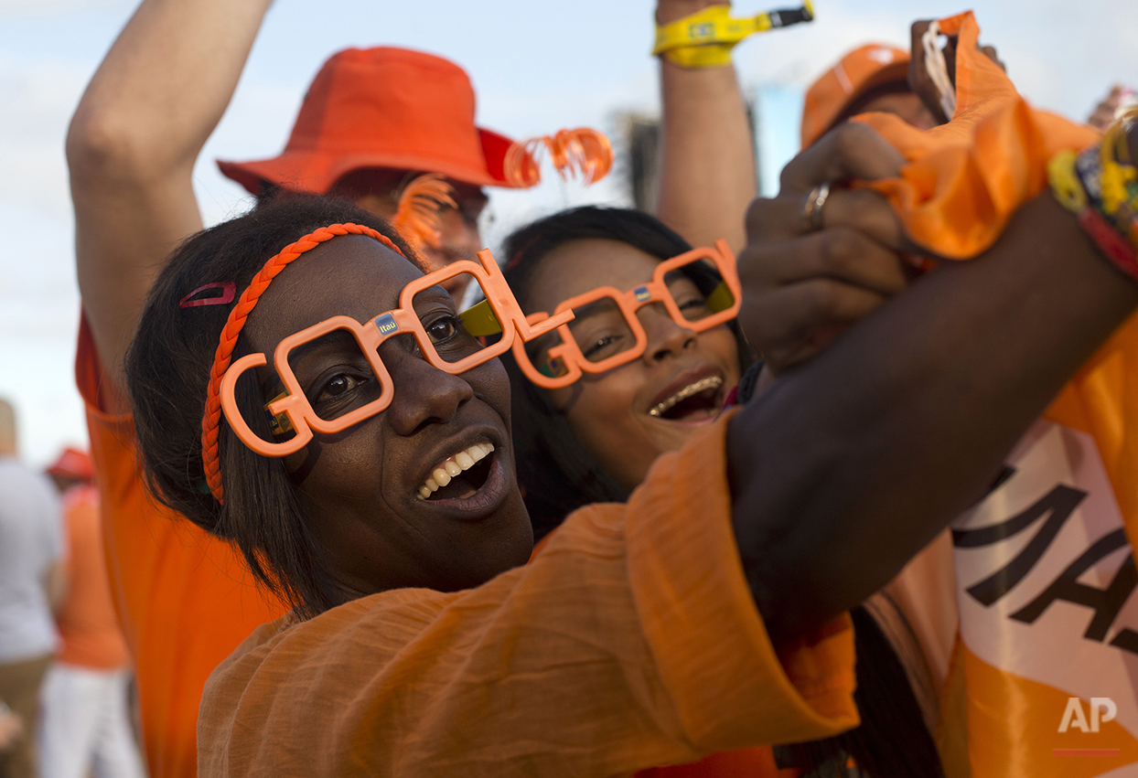  Netherlands soccer fans cheer during a live broadcast of their team's World Cup semifinal match against Argentina inside the FIFA Fan Fest area on Copacabana beach, in Rio de Janeiro, Brazil, Wednesday, July 9, 2014. (AP Photo/Silvia Izquierdo) 
