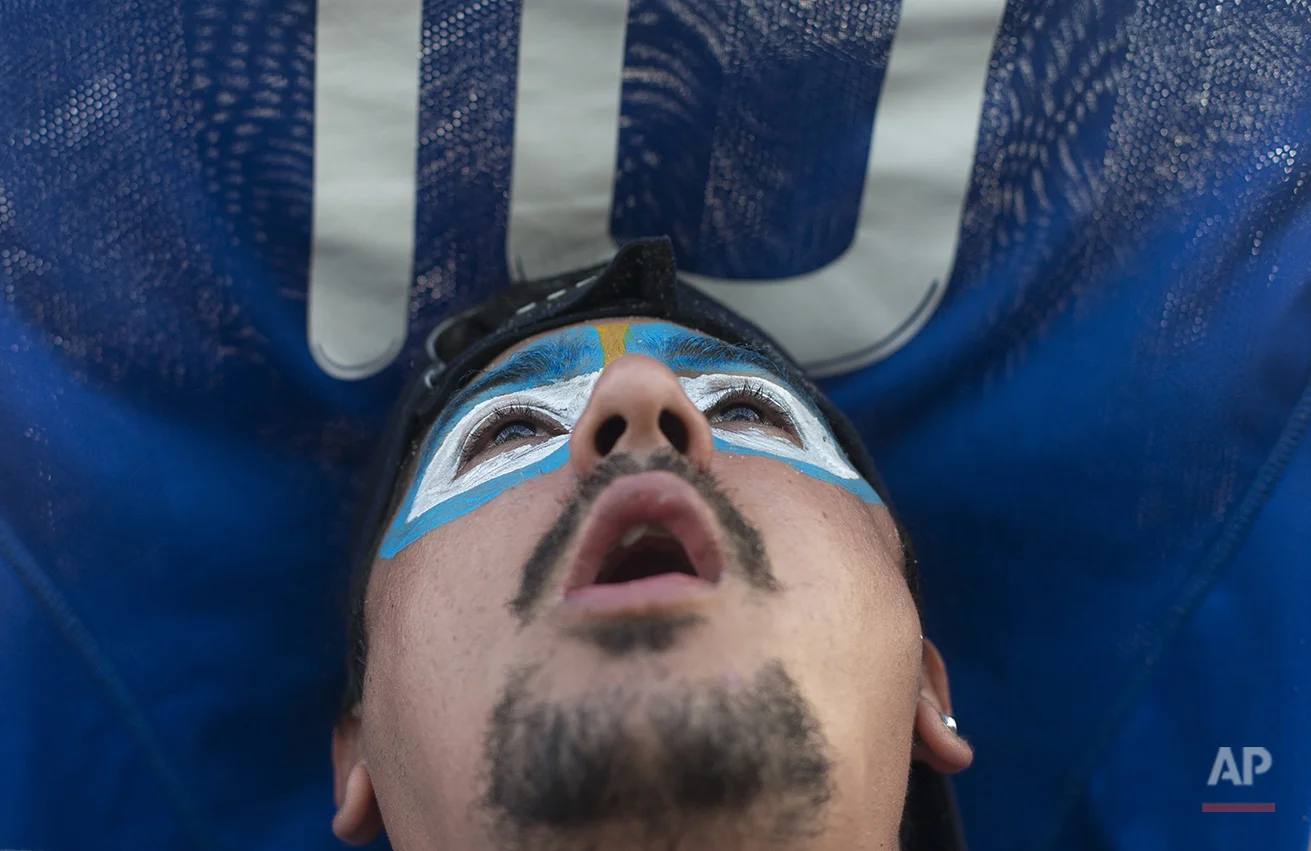 A soccer fan of the Argentina national soccer team watches a live telecast of the soccer World Cup semifinal match between Argentina and The Netherlands, inside the FIFA Fan Fest area on Copacabana beach, in Rio de Janeiro, Brazil, Wednesday, July 9, 2014. (AP Photo/Silvia Izquierdo)