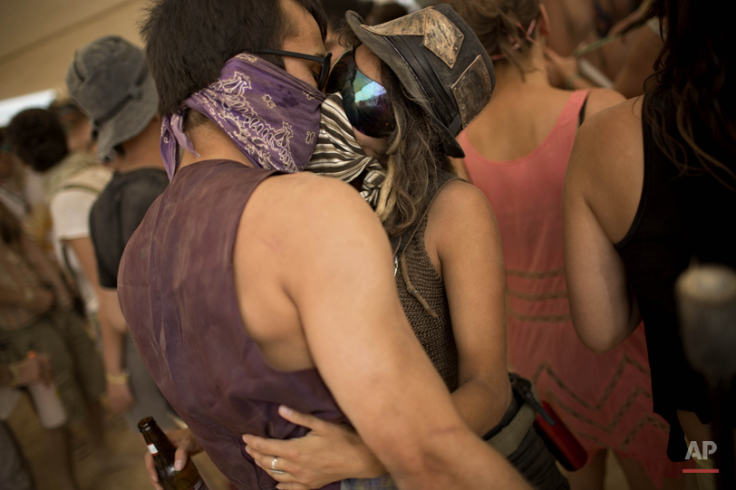  In this photo taken Thursday, June 5, 2014, Israelis kiss at a party during Israelís first Midburn festival, modeled after the popular Burning Man festival held annually in the Black Rock Desert of Nevada, in the desert near the Israeli kibbutz of S