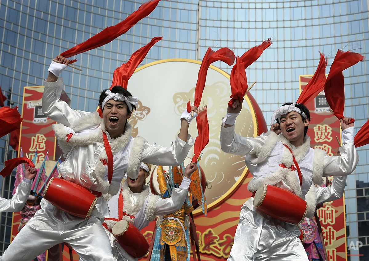 A group of artist from Shanxi province perform drum dance outside an office buildings on the 9th day of the Lunar New Year celebrations in Beijing, Monday, Feb. 22, 2010. Millions of Chinese are returning to work or study when the week-long Spring Festival holiday draws to an end on Friday. (AP Photo/Andy Wong)